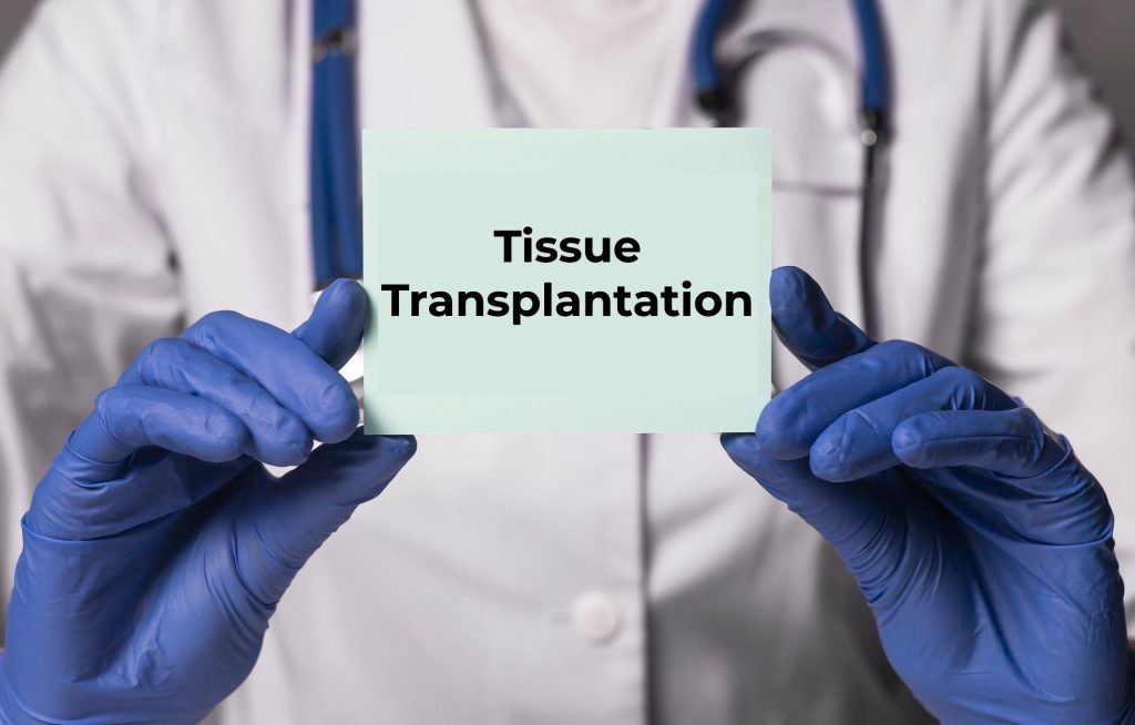 A doctor holding a Tissue Transplant Plastic Surgery sign