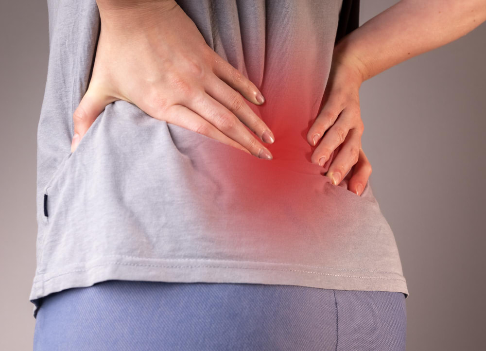 A woman with back ache pain in her spine and bone disease
