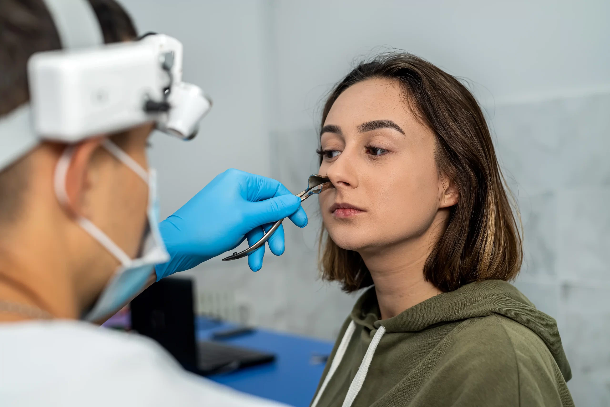 male-doctor-examines-nose-patient